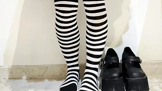 Goth crushing a banana under her shoes