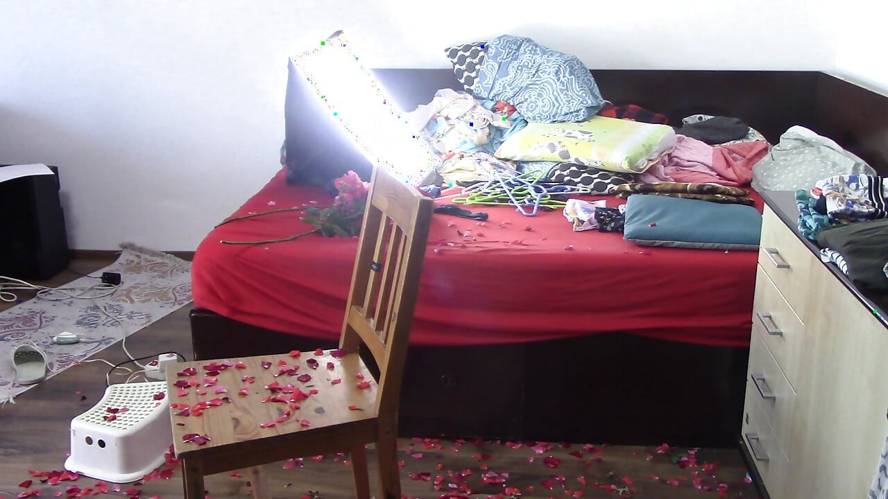 Amateur wife cleans the house with the vacuum cleaner. Sexy has fun with roses naked.