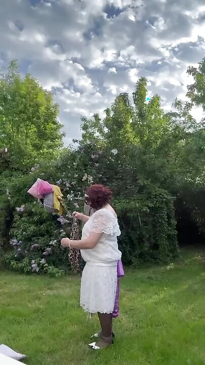 Dressed in a white lace dress to hang the laundry