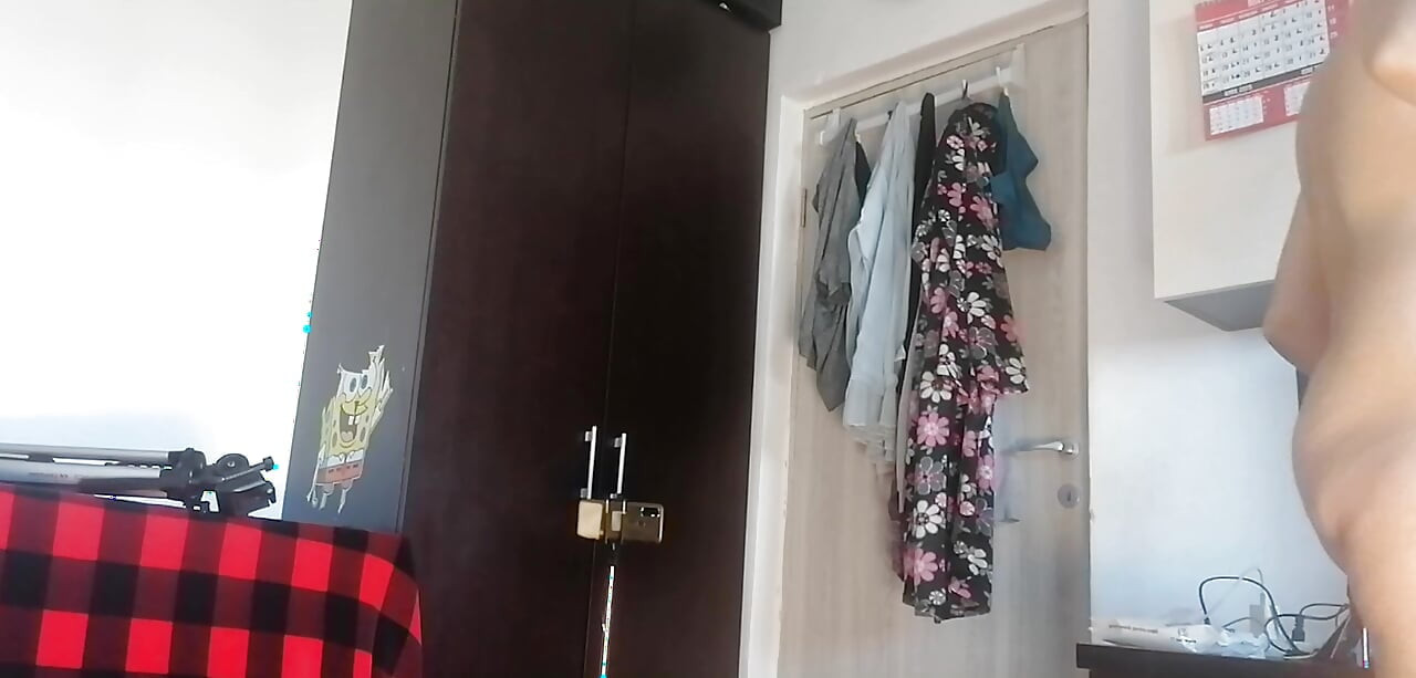 Amateur woman has fun trying on clothes and cutting them. Amateur woman vacuums naked in the house.