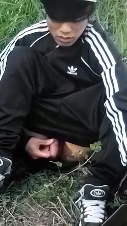 Cute Asian gay twink in a black-and-white adidas tracksuit and Campus sneakers masturbates and cums outdoors | Clip 1