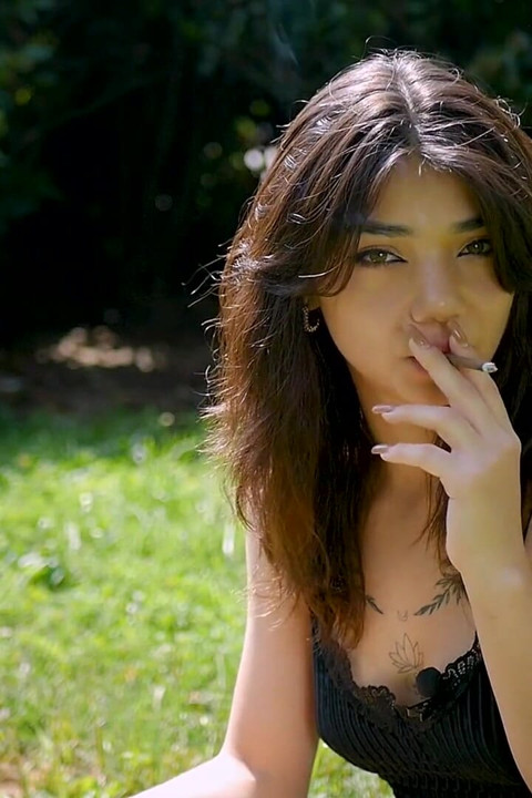 Arina Is Smoking One Black Cigarette Outdoors