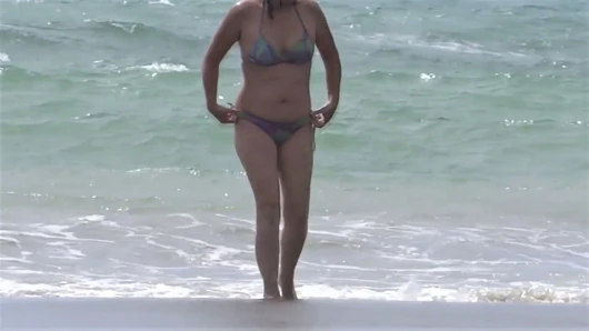 Hairy mature shows off on the beach while masturbating