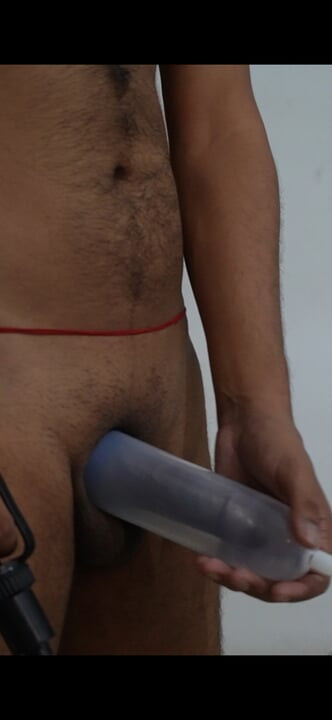 In this video, a penis pump is used to enlarge his cock