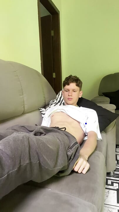 Skinny twink showing his big dick at the sofa