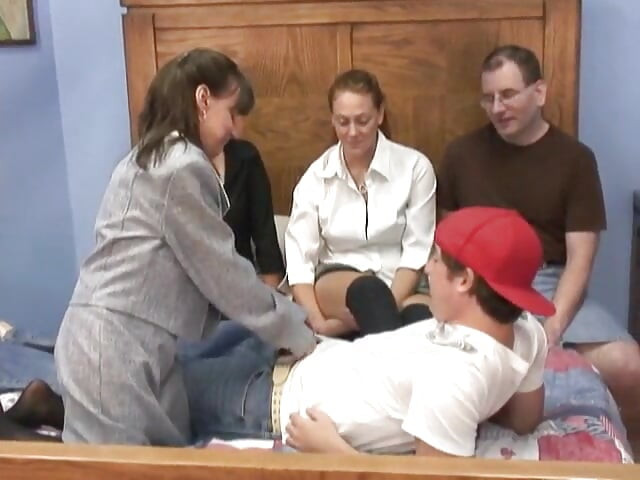 Mature Brunette Sucks Young Guy as Two Cute Coeds Share Old Penis on a Bed