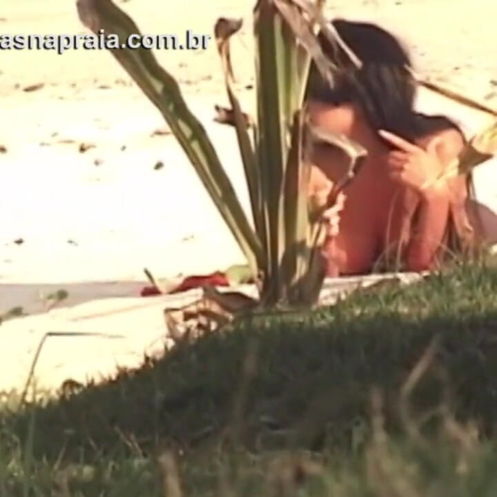 Wonderful blonde and brunette take sunbathing naked on a beach of Brazilian nudism