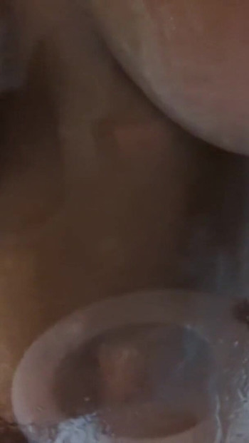 Captivating moment from "Watch my milf wife showing off her tanned body and big natural tits whilst taking a shower and"