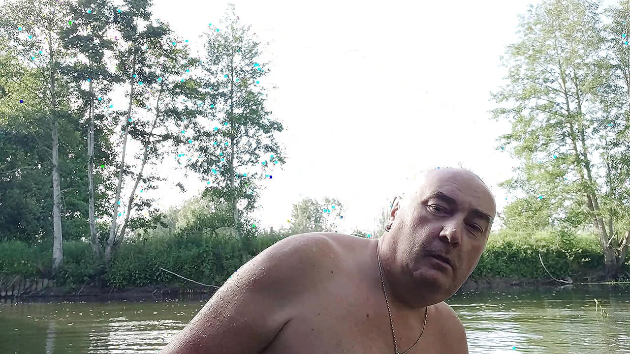 The plump, mustachioed daddy is having a blast in the stream, shamelessly masturbating with mud