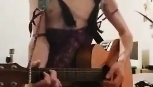 In a garter bodysuit... I exibe and sing sex on the guitar, in the style of a horny little naughty slut...!! ...