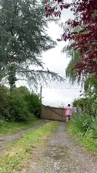 Dressed in a pink maid outfit to go get a package from the mailbox