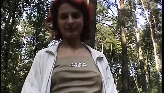 Redhead chick plays with her pussy outdoors