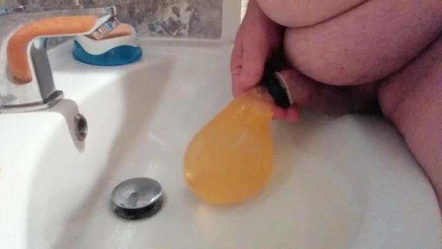 PISSING INTO A CONDOM