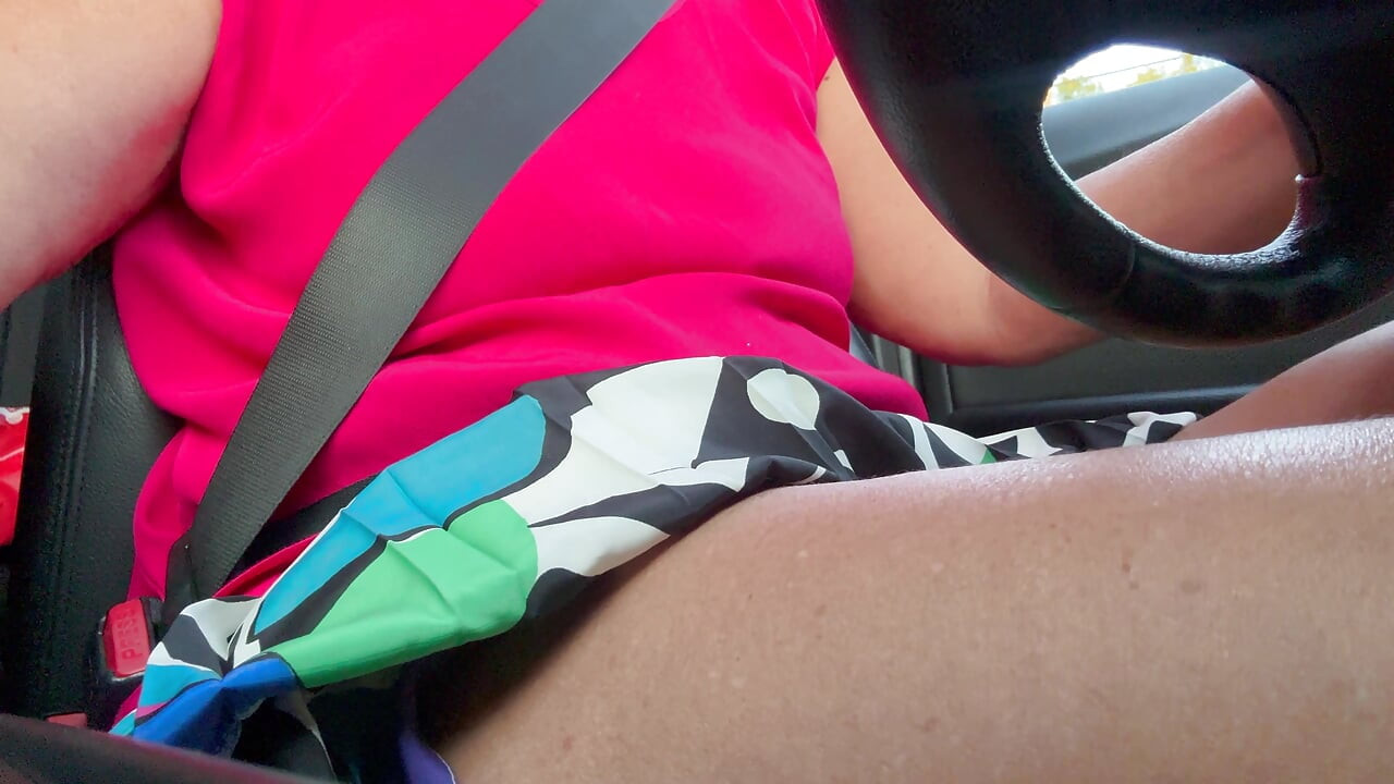 The beautiful, deceitful wife slips her hand between her thighs and rubs her wet pussy while driving.