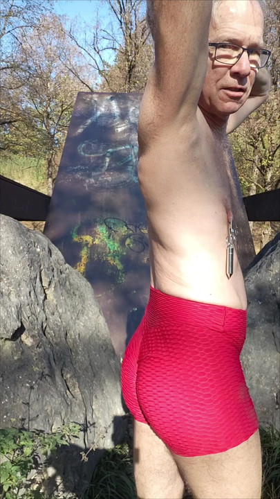 The slave presents himself in eye-catching red panties, takes off his clothes completely and shows his long stretched nipples.