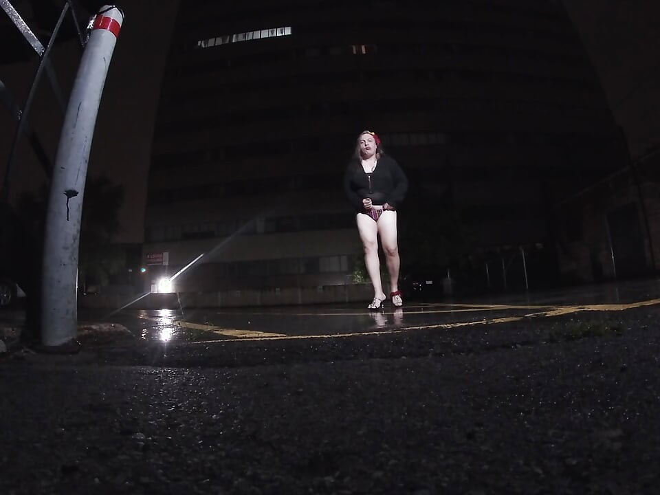 Mature sissy CD out in the rain in A parking lot in public masturbation.