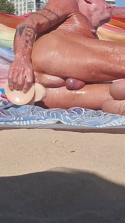 Key West oiled up using his new huge dildo at the beach