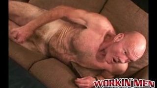 Old man lays back and pulls on his cock until it gets hard