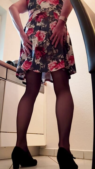 Secretary in floral dress pampering herself in coffee kitchen