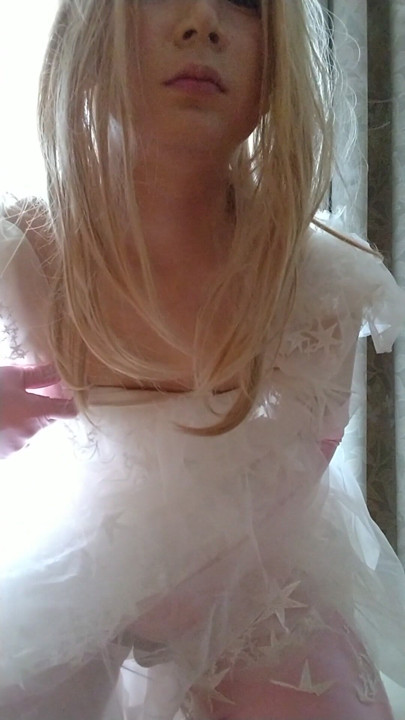 A cross-dressing boy wearing a white wedding dress masturbated comfortably while touching his dick with pink gloves. | Clip 1