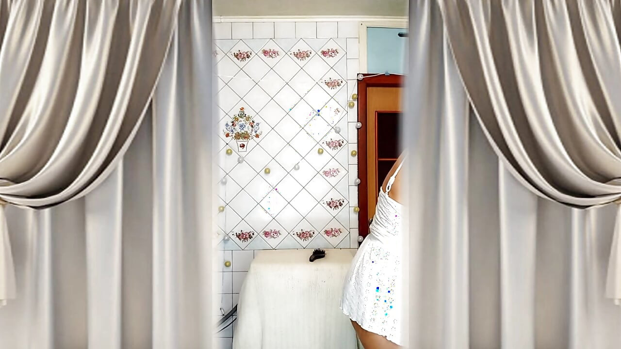 Real home solo of a mature woman in a small cozy kitchen.