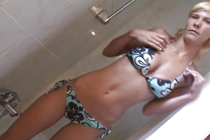 Slim German lady playing with her toys in the shower