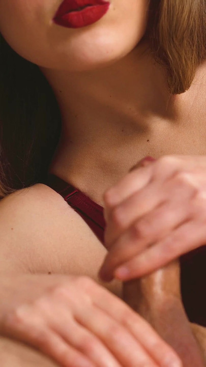 Captivating moment from "A beauty in sexy lingerie and red lips jerks off her boyfriend and brings him to orgasm."