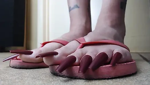 Long red toenails pink flipflops