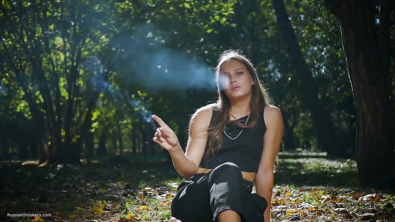 Seductive Russian Beauty Smoking Cigarette in Studio