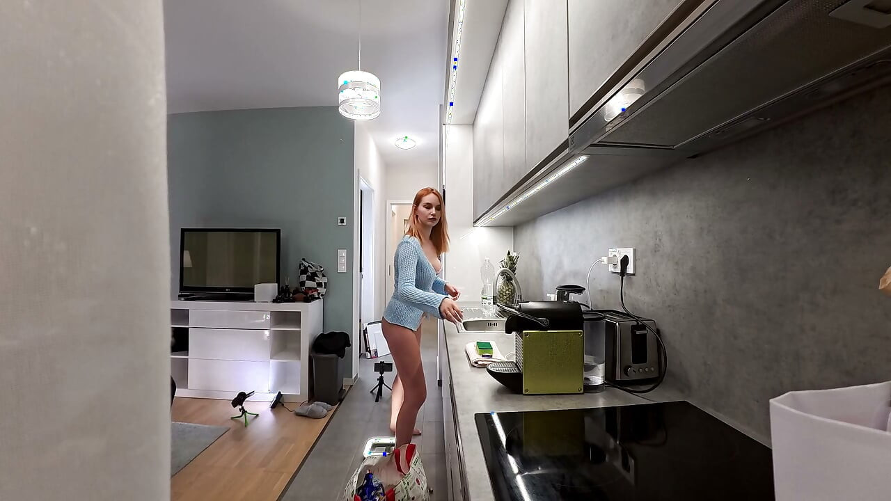 Hot big tits wonderfully beautiful redhead in the kitchen with a cardigan and thong shows her beauty and long legs