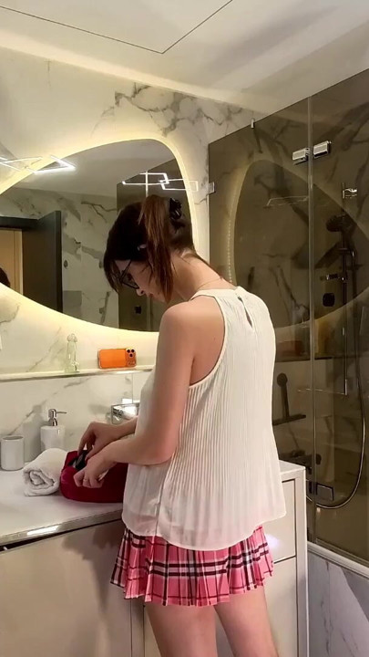 Long legs nerdy college girl with a short skirt and panties shows off in the bathroom | Clip 1