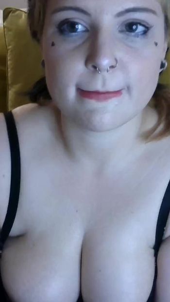 Goth girl puts lotion on boobs