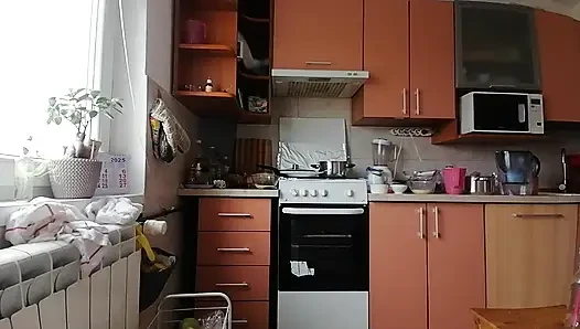Sexy brunette doing naked chores around the house.