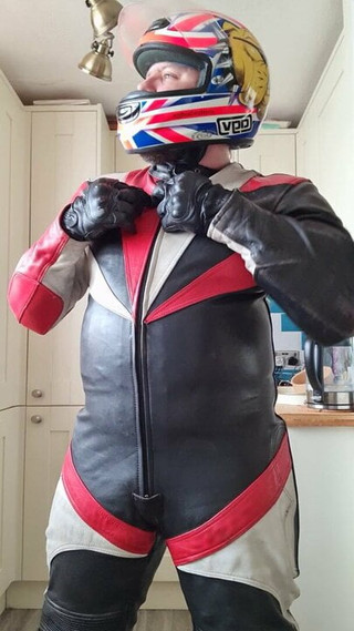 Wanking in biker leathers and helmet