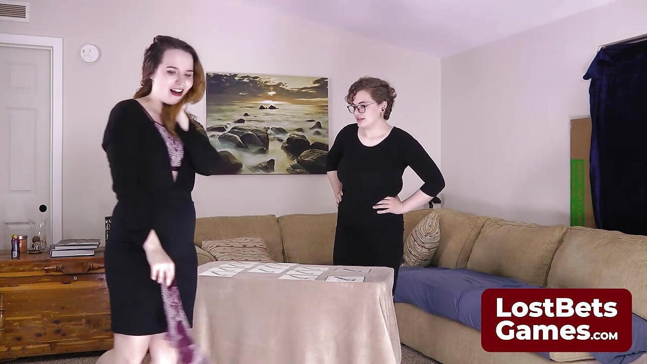 Both girls are fumbling through a Strip Memory card game