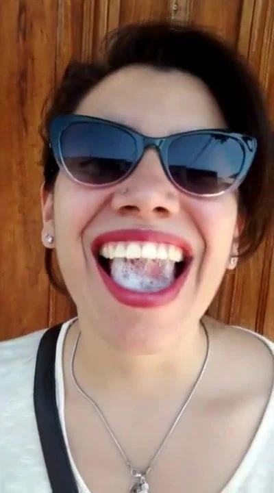 Pretty Girl Plays With A Mouthful Of Cum On The Street