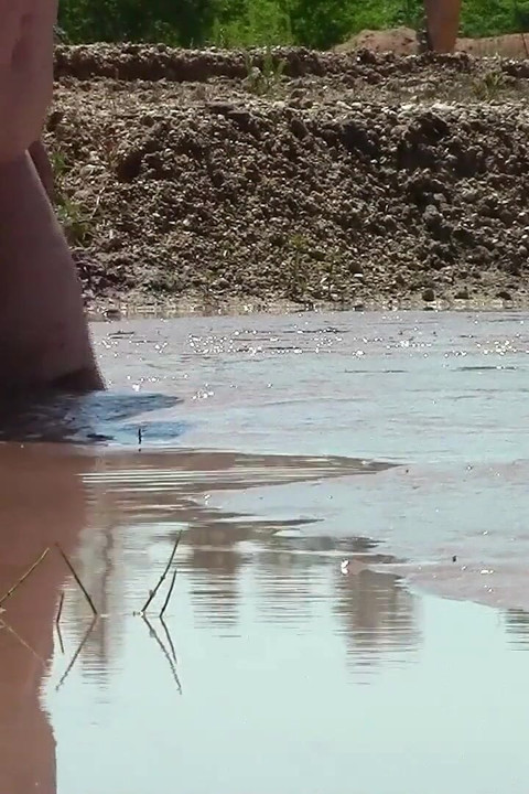 Deep, Creamy Brown Mud Bath in a Sand Pit