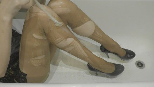 A menina rasga a meia-calça e cobre as pernas delgadas com esperma