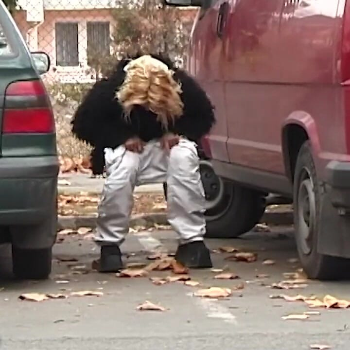 Girl peeing between the cars
