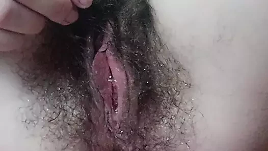 Big wet hairy pussy pissing. Water drops on pussy hair.