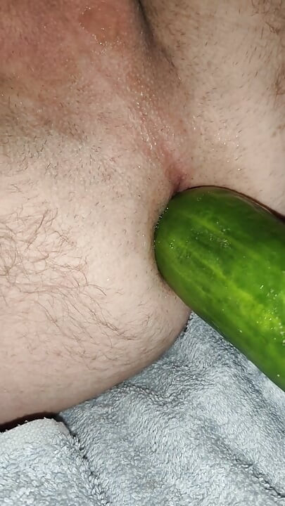 My wife is fucking my ass with a huge cucumber.