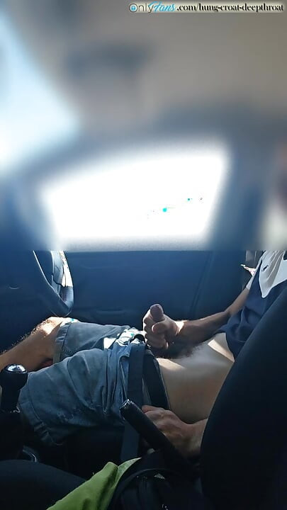 Cumming in a car by the road