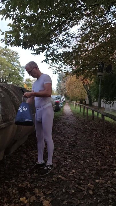 The provocative slave disposes of waste glass at a glass container