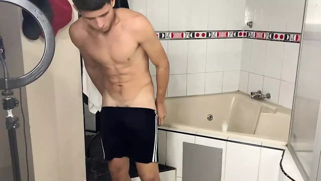 Attractive young man with a beautiful body takes a delicious bath