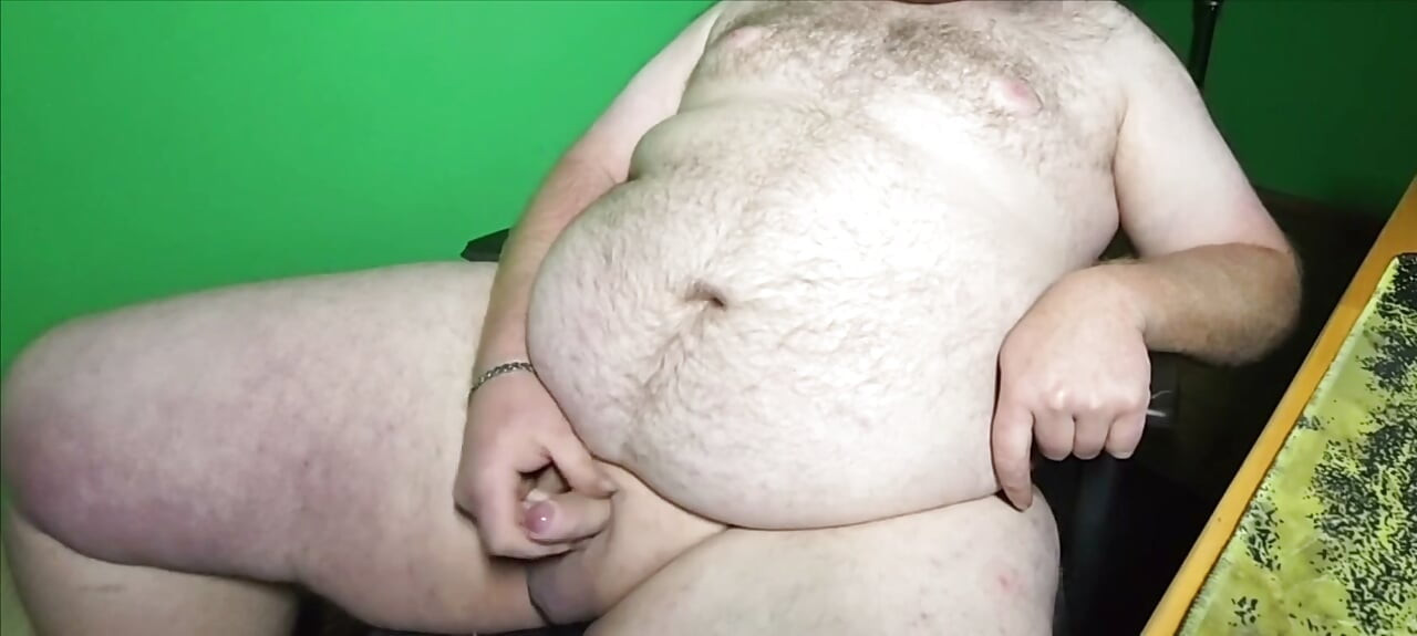 A fat boy with a small dick is masturbating.
