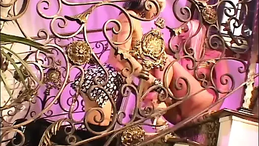 Two lesbian blondes share some sex toys on the stairs