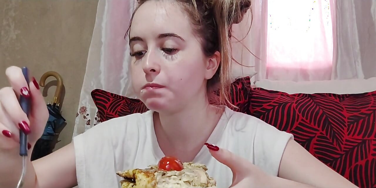 Eating an omelette sandwich with cherry tomatoes