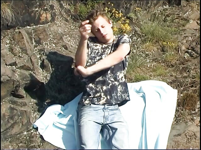 Young twink jerking his dick while on picnic