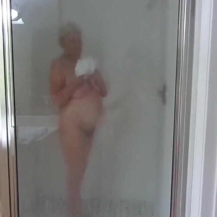 Sexy mature blonde granny takes a shower as we stepdaughter films