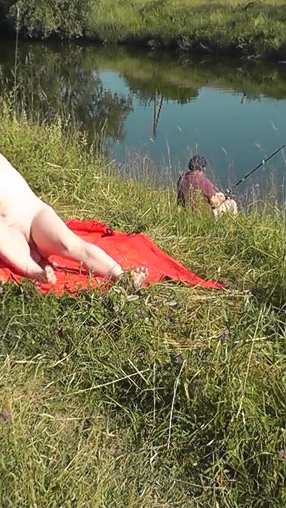 Iconic moment from "Wild beach. Sexy MILF Platinum naked sunbathing on river bank, random fisherman guy watches. Naked in"